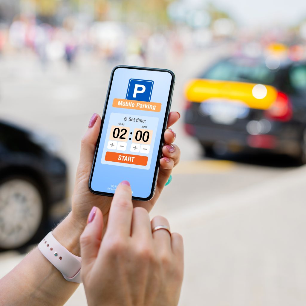 Woman Using Mobile Parking App on Her Phone to Pay
