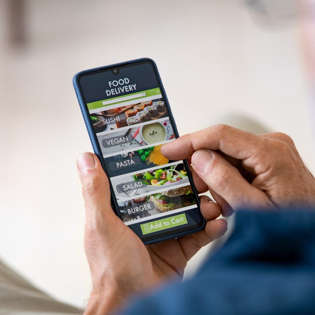 Man Using Mobile App to Order Delivery Food